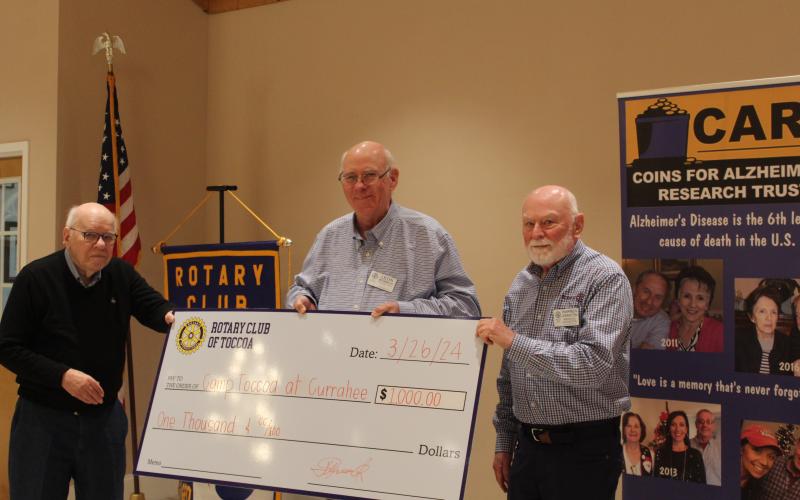 The Toccoa Rotary Club presented Warren Johnston, right, a check for $1,000 for Camp Toccoa at Currahee.