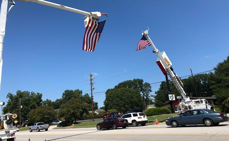 This was the scene Tuesday afternoon on Big A Road – large American flags draped across the roadway in honor of the late Stan Elrod.